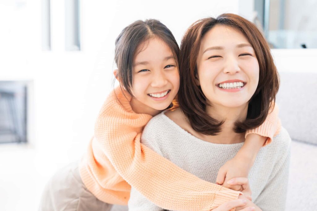 小児矯正で綺麗な歯並びとなって喜ぶ親子