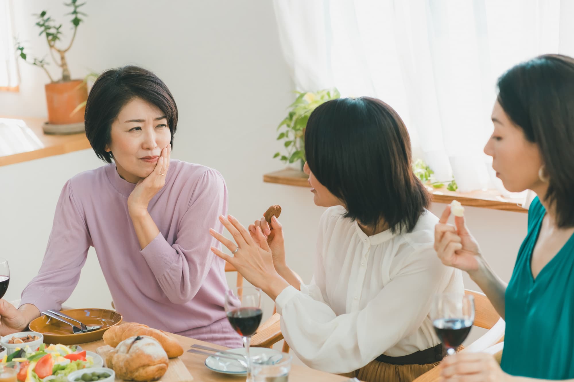 食事中に顎が痛む女性